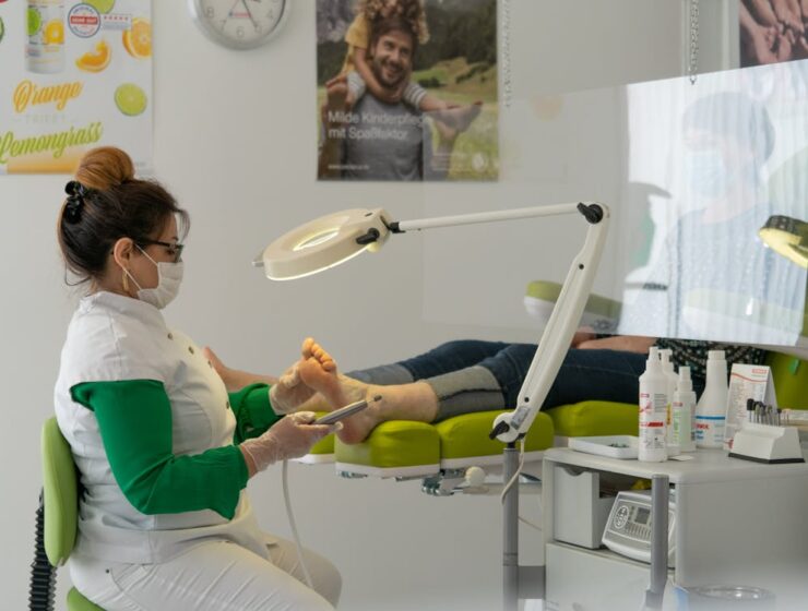 Podiatrist performing a foot treatment procedure on a patient in a clinic