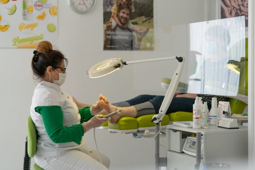 Podiatrist performing a foot treatment procedure on a patient in a clinic